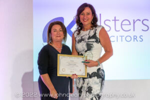 Sharon being presented an Award on stage